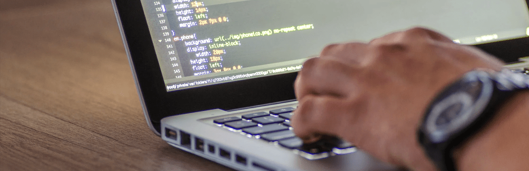 software developer computer hand typing codes